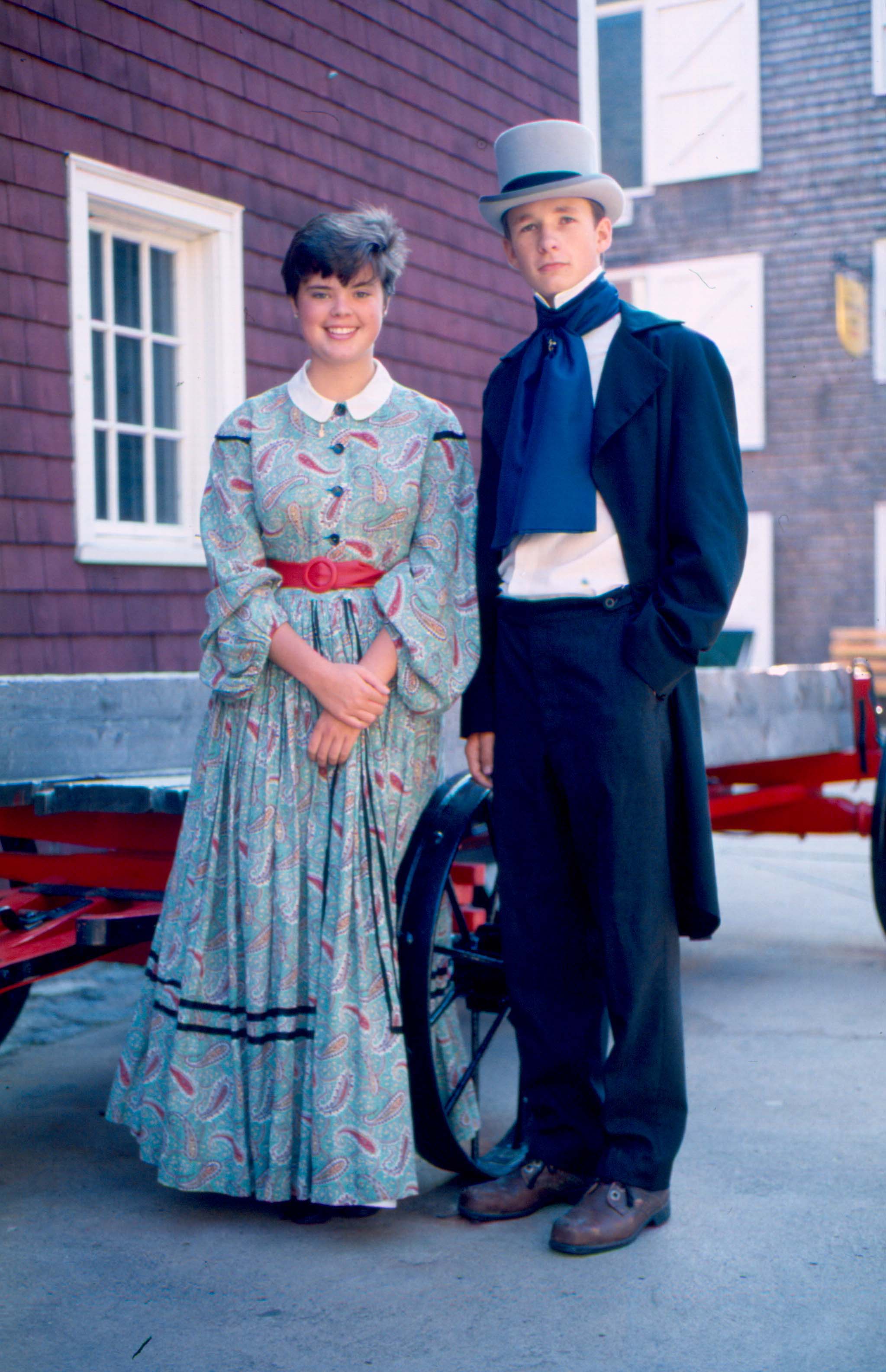 Colour photo of the two youngsters in Victorian dress at Historic Properties
