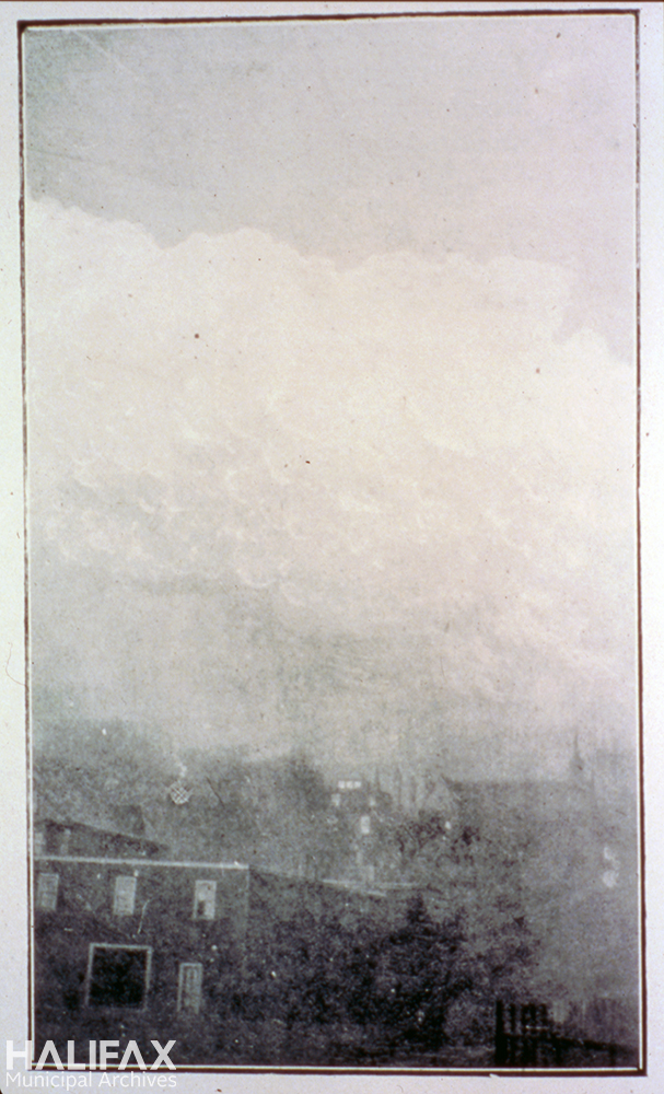 Black and white photograph of smoke above houses