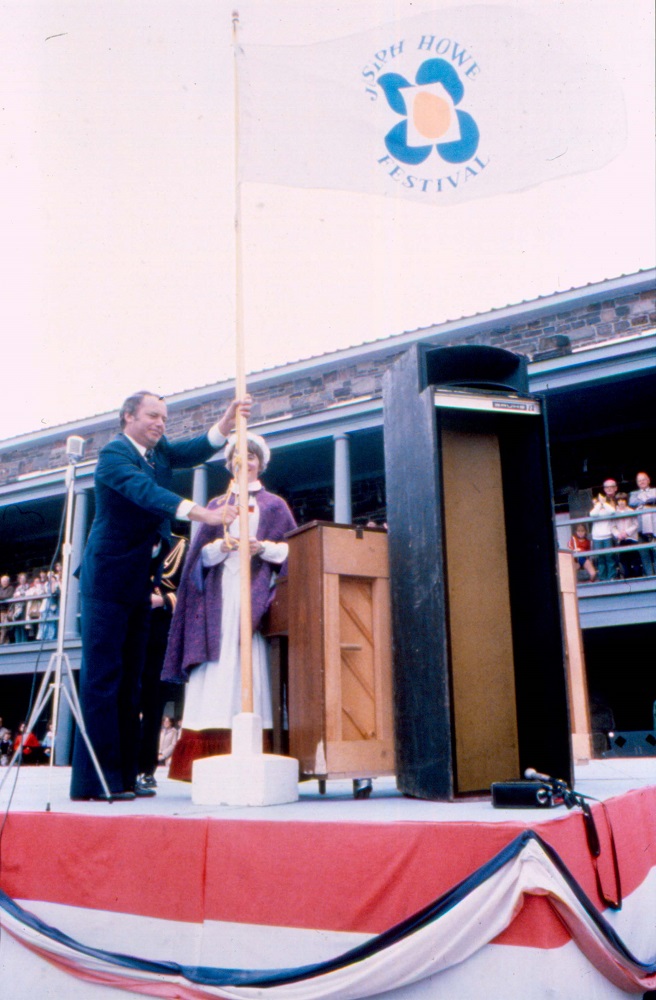 Colour photograph of a ceremonial flag raising event