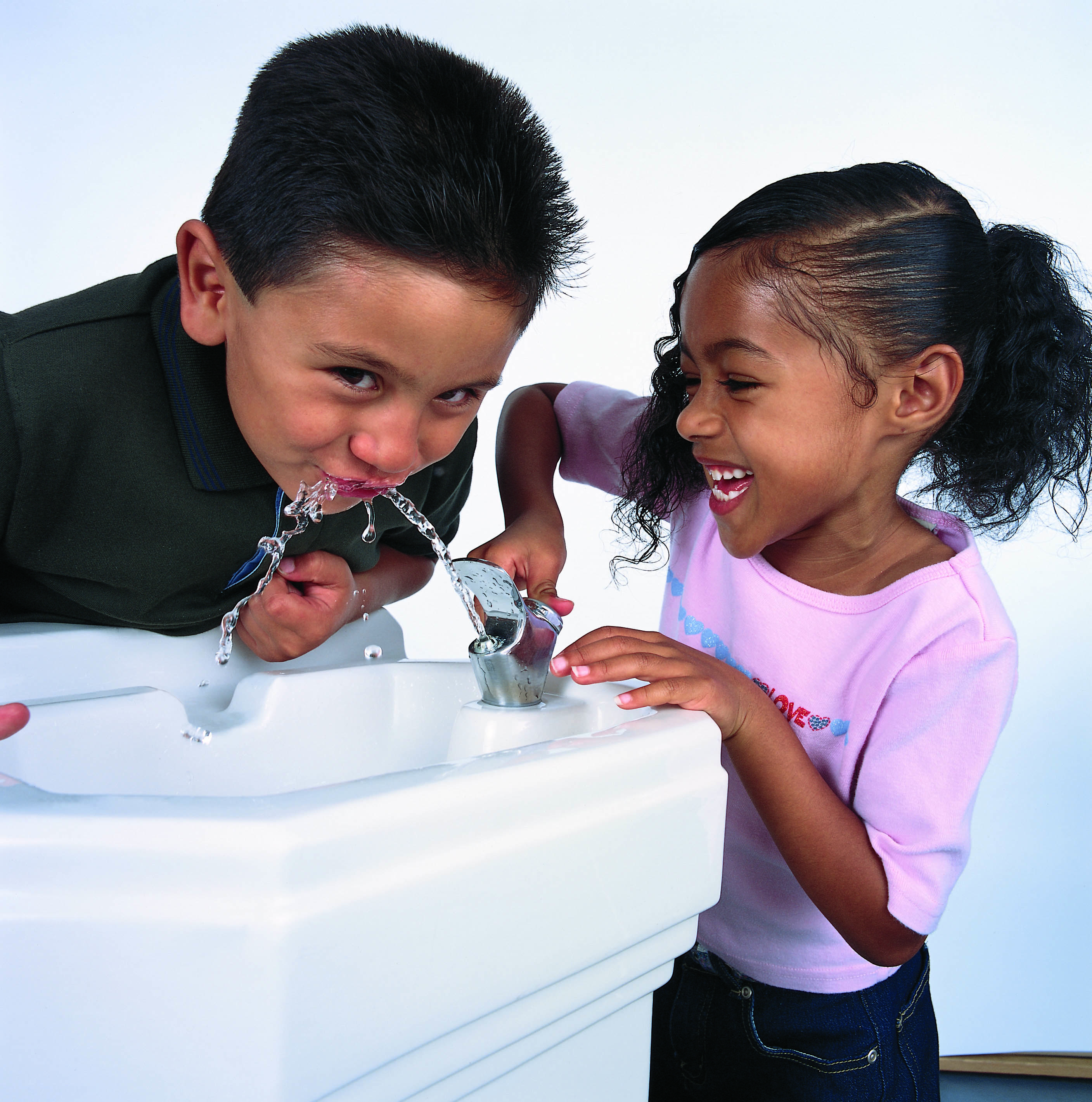 Children drinking clean water from a fountain