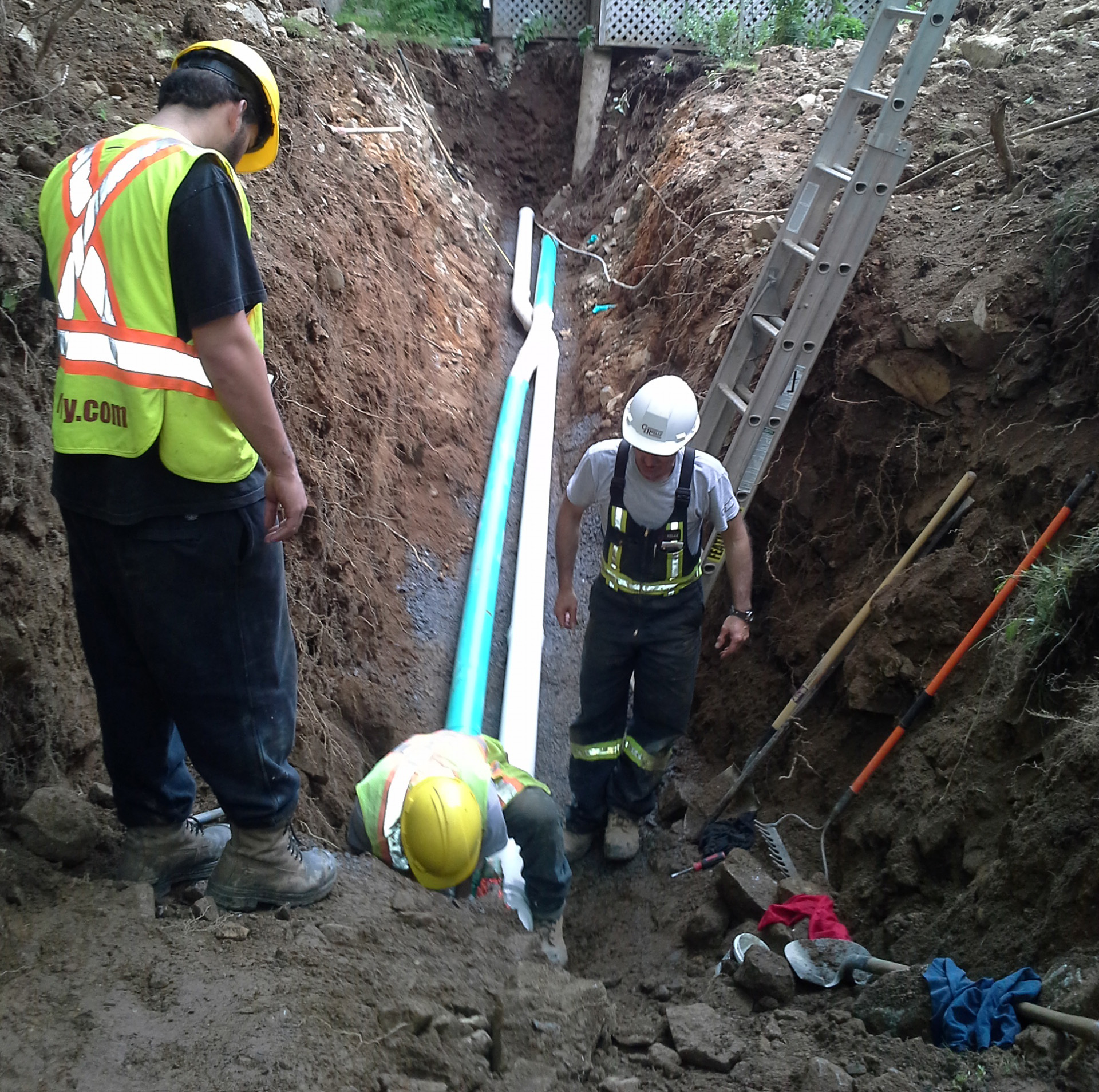 Three contractors completing a private lateral replacement.