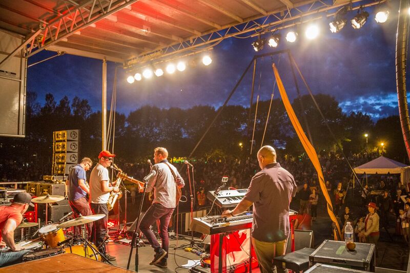 A backstage shot of a band playing on the main stage at Bedford Days