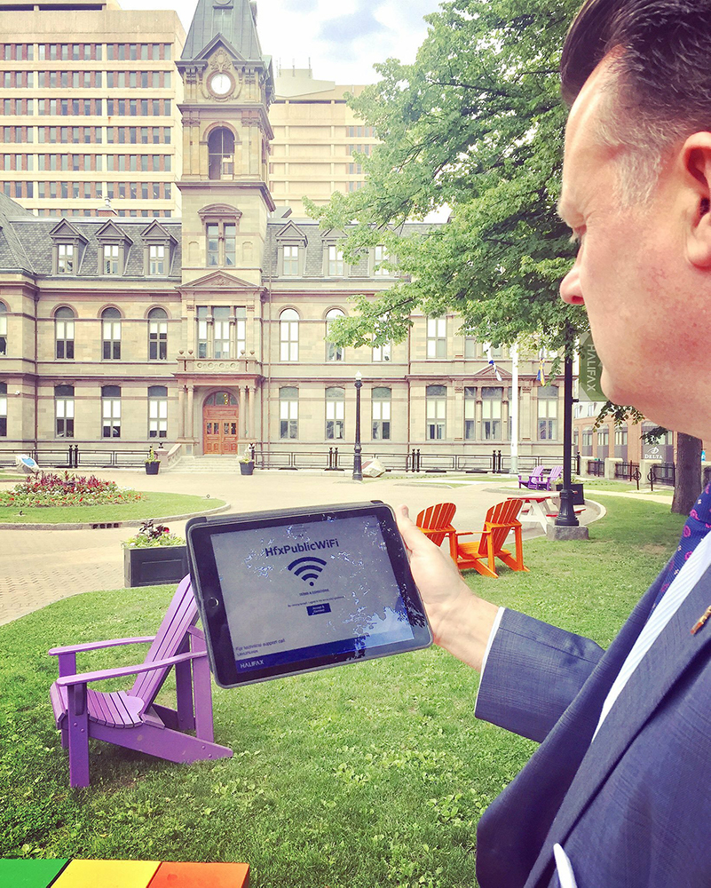 a photo of the mayor using public wifi on an ipad
