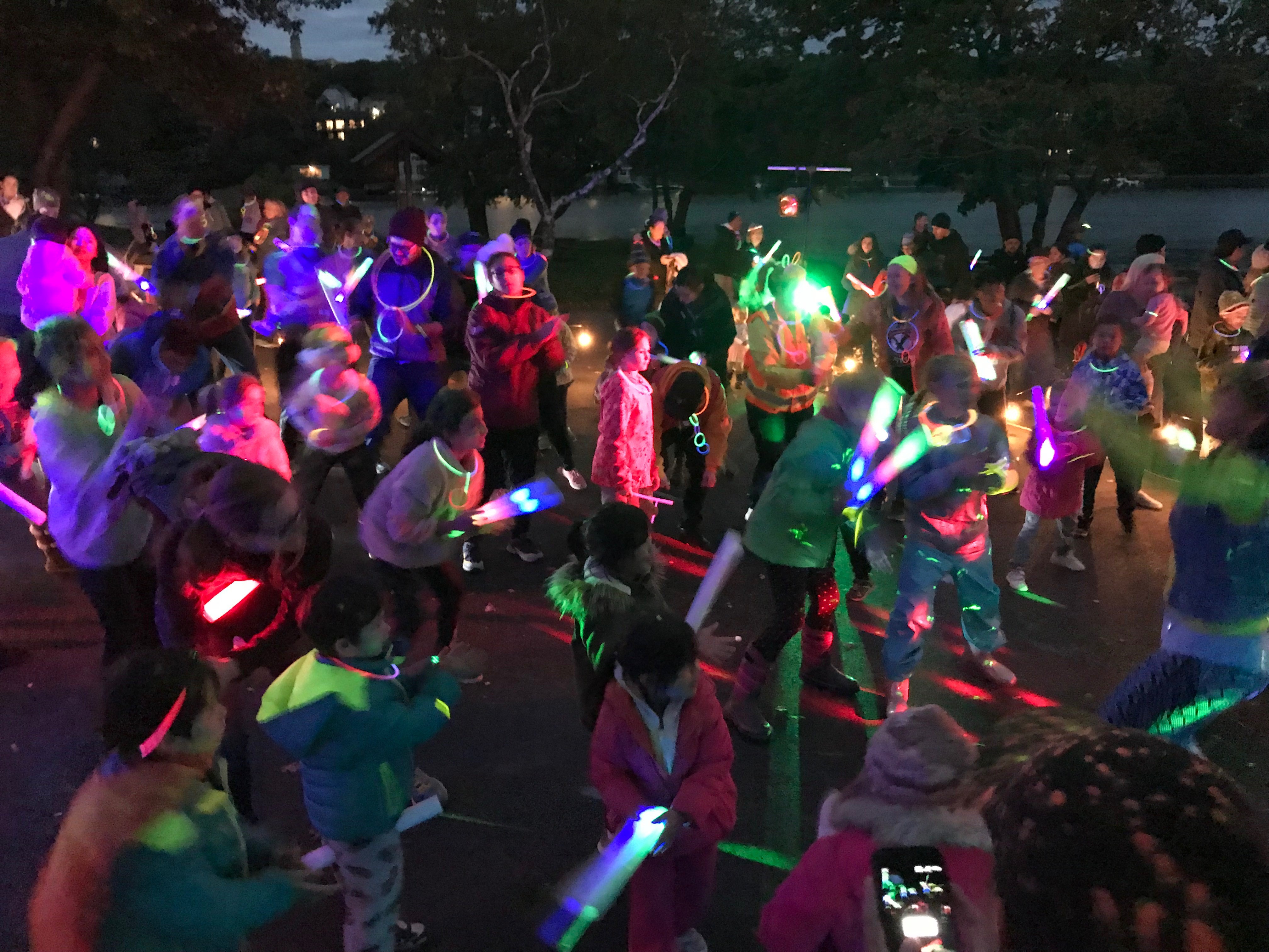 crowd dancing at Glow in the Park event