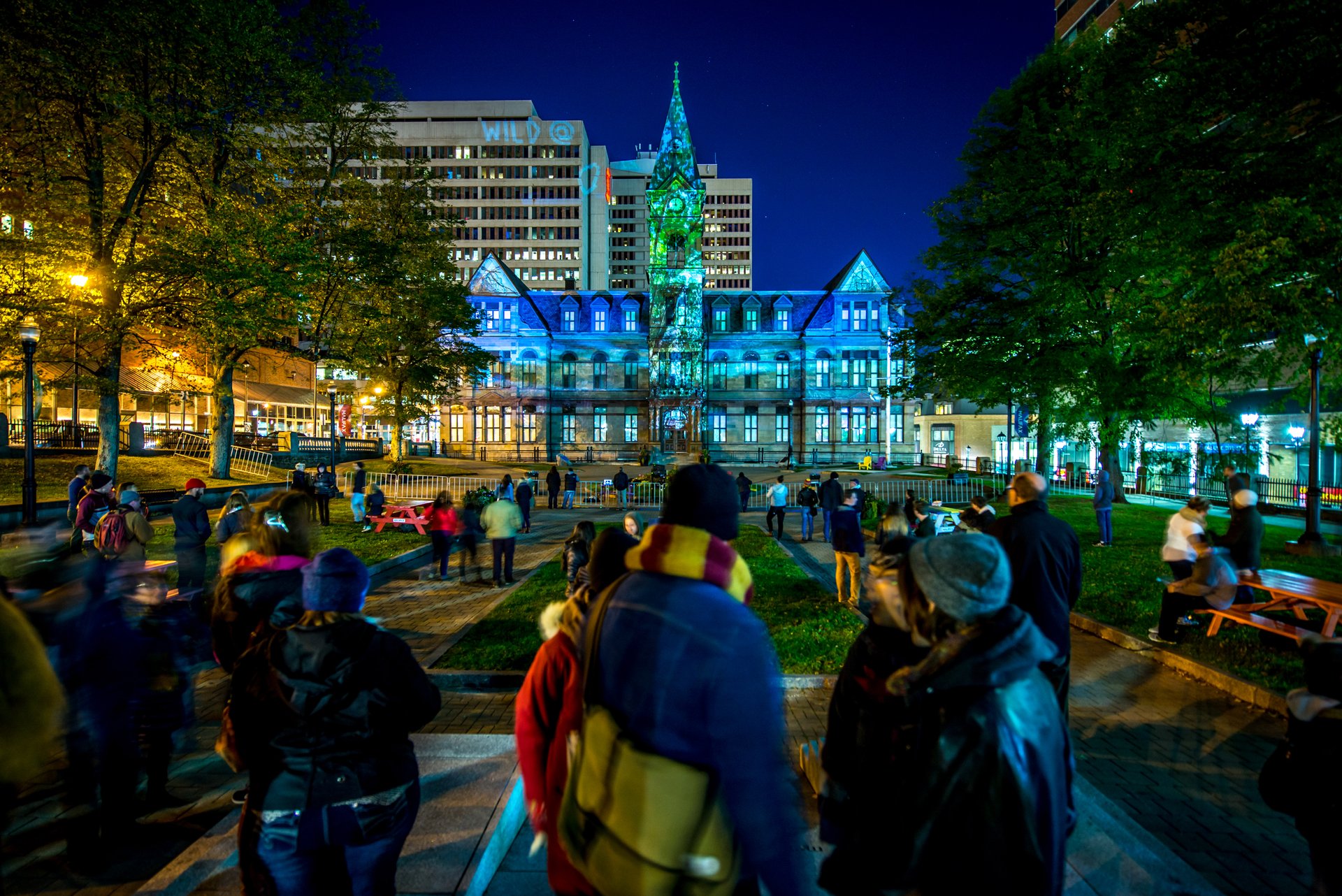 A photo of city hall lit up during nocturne art at night festival