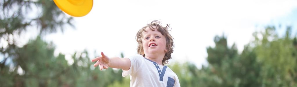 child throwing frisbee