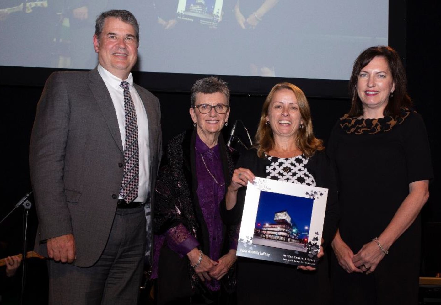 Diane Chisholm, second from right, accepting the Award on behalf of the municipality