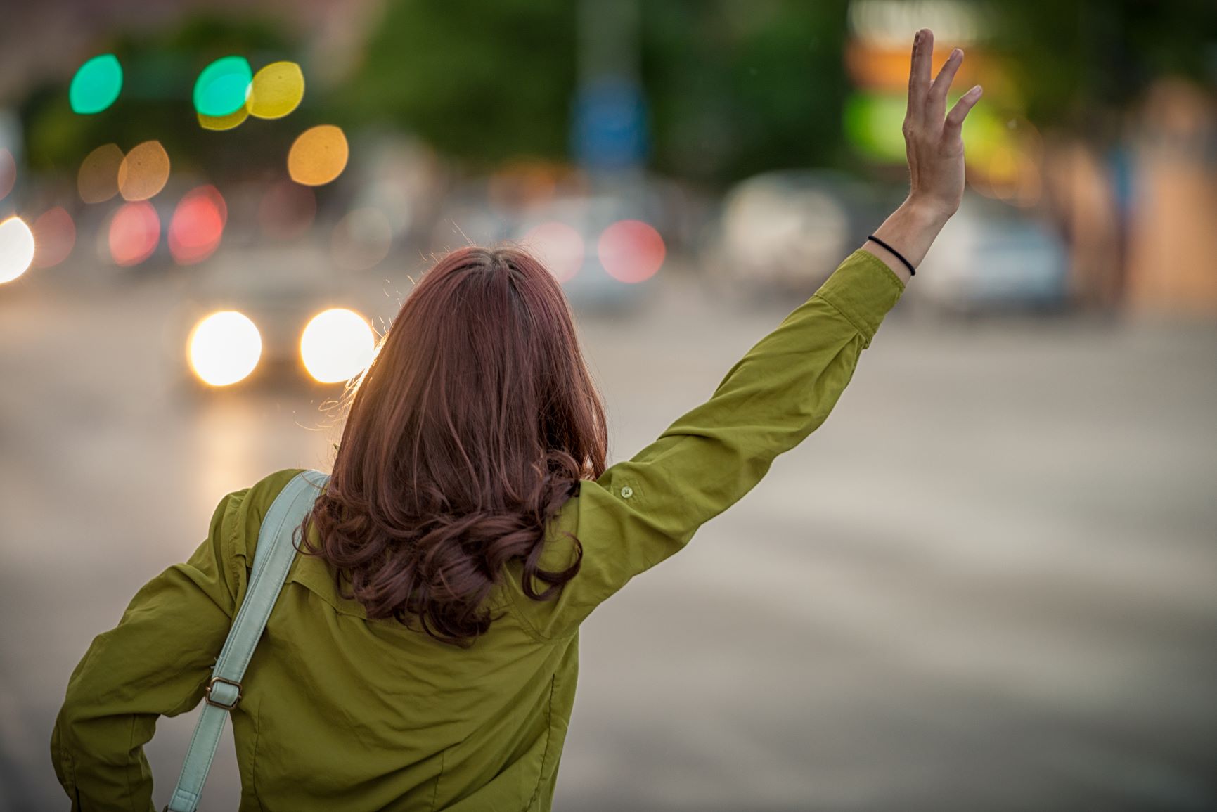 An image of a woman hailing a taxi