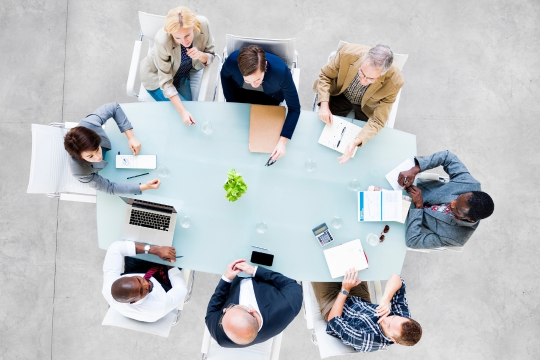 A group of people at sitting at a conference table