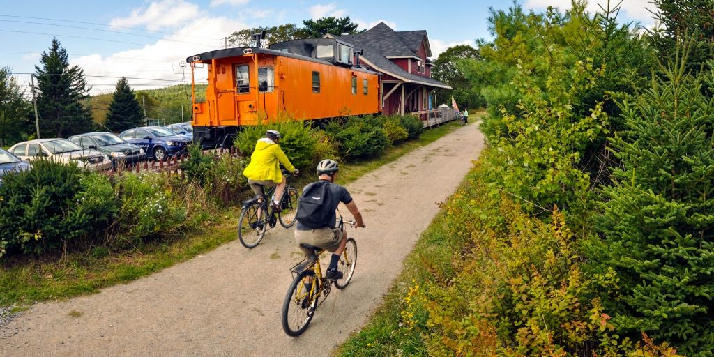 Two adults biking on a trail in rural Halifax