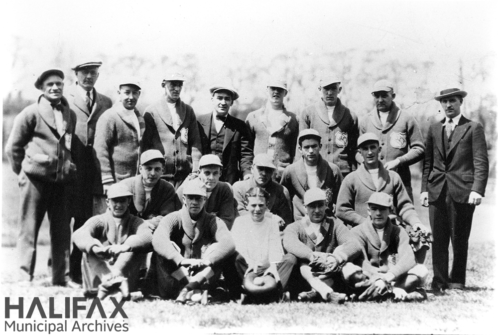 Black and white photograph of a baseball team posing outdoors