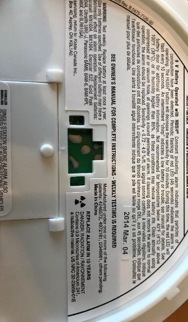 Close up of the back of a smoke alarm showing it's instructions