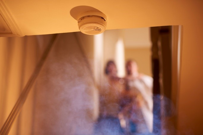 Smoke rising up toward a smoke alarm