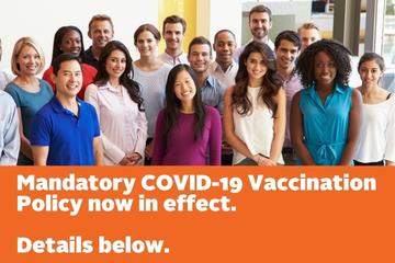 A group of diverse people stand and smile. Text banner reads: "Mandatory COVID-19 Vaccination Policy now in effect. Details Below."