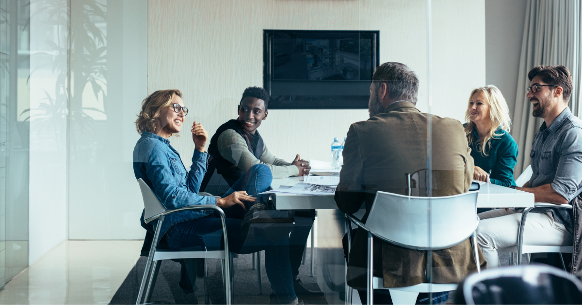 A group of people are meeting in a boardroom