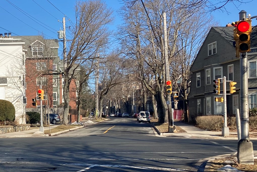 Traffic Signals showing a red light for vehicles with a leading pedestrian "walk" signal displayed