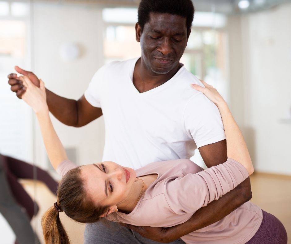 Two people ballroom dancing in a dance studio