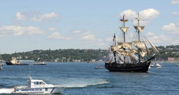 Bluenose 2 in the harbour next to a police boat