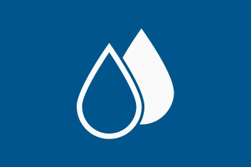 Two water droplets one see through and one solid white against a navy blue background