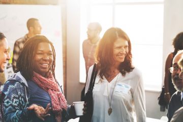 a group of people chatting after a committee meeting