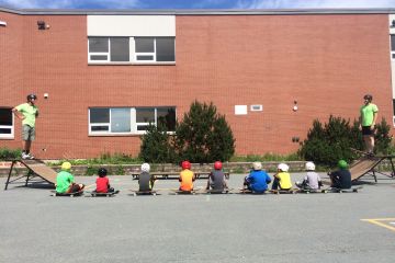 children sit beside skateboards at recreation facility in Sackville