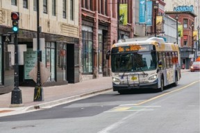 A Halifax Transit bus driving down Barrington Street on a sunny day