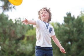 child throwing frisbee