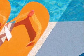 Flip flops beside a swimming pool