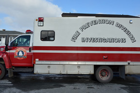 A large red and white cube van with a Halifax Regional Fire and Emergency Logo on the door and the words Fire Prevention Division Investigations on the side of cube van
