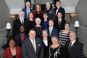 Members of Regional Council stand together on the staircase inside City Hall