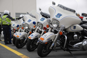 A line of Police branded motorbikes next to two police officers