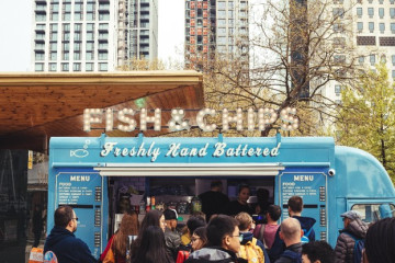 People lined up at a food truck waiting to order Fish & Chips